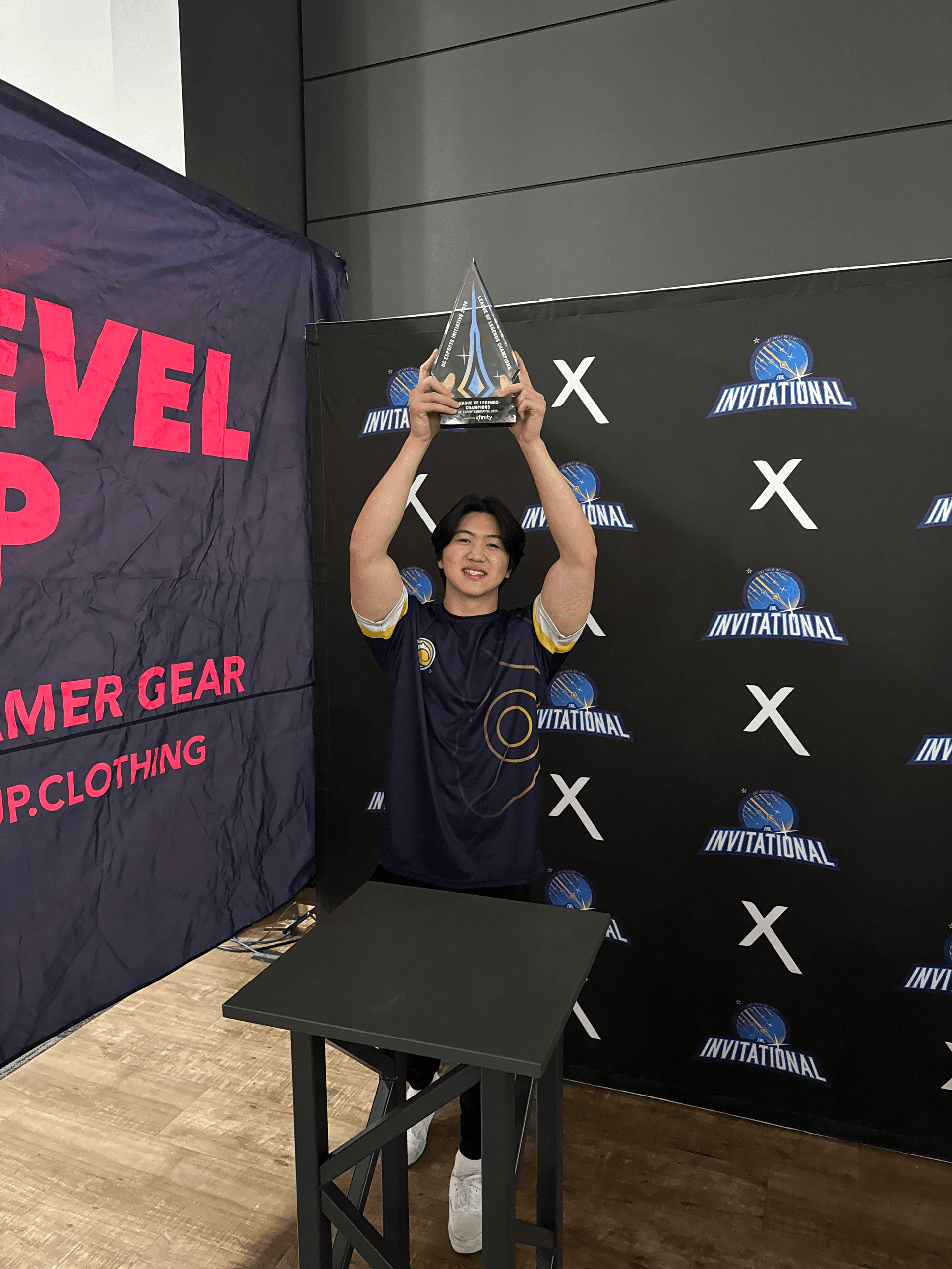 Matthew holding the UC Irvine Esports League of Legends championship trophy